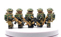 Five military minifigures in camouflage uniforms and helmets, each holding a black and tan rifle, standing on a white circular platform against a white background.